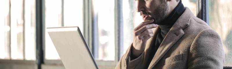 man-wearing-brown-jacket-and-using-grey-laptop-874242.jpg