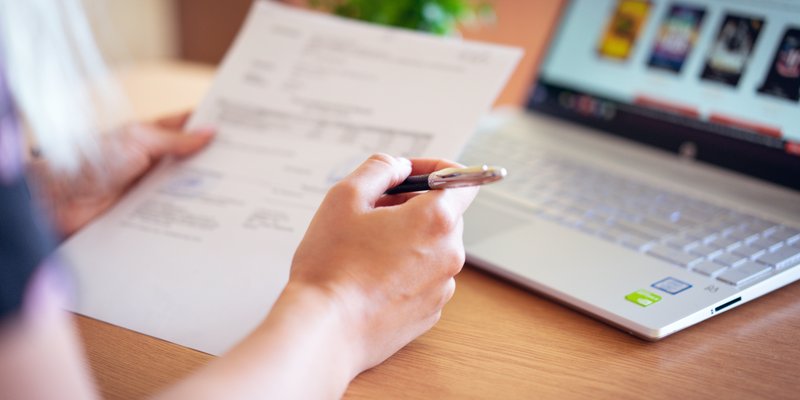 person-holding-pen-and-paper-2646033.jpg